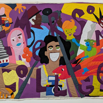 Colorful, appliquéd quilt featuring smiling face with huge smile
