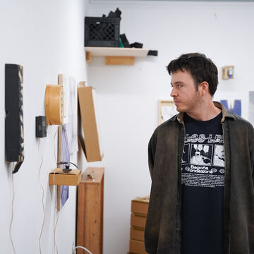 Pedro Albertini, an adult person with a fair skintone, in a gallery space. 