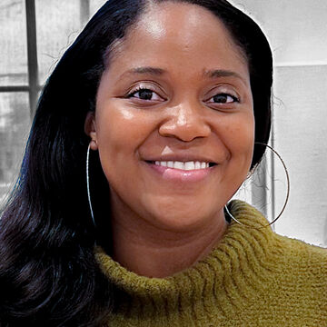 Headshot of Cassandra Scanlon, an adult Black person with a medium-deep skintone and dark hair. 