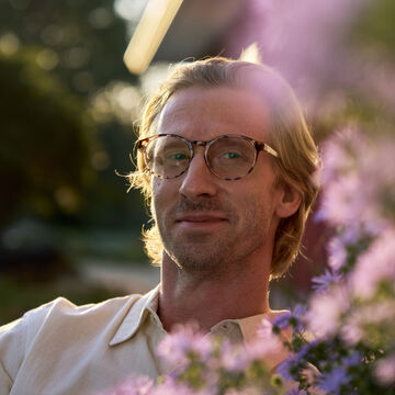 Craig Hartenberger standing outside in the sun.