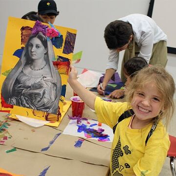 Student smiles in front of her project