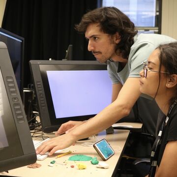 Faculty and student review content on computer monitor