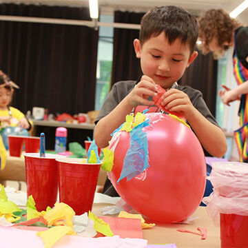 Student works on paper mâché project