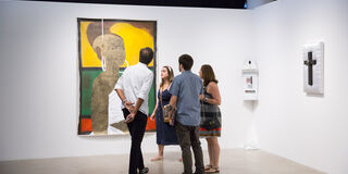 A group of people in a gallery.