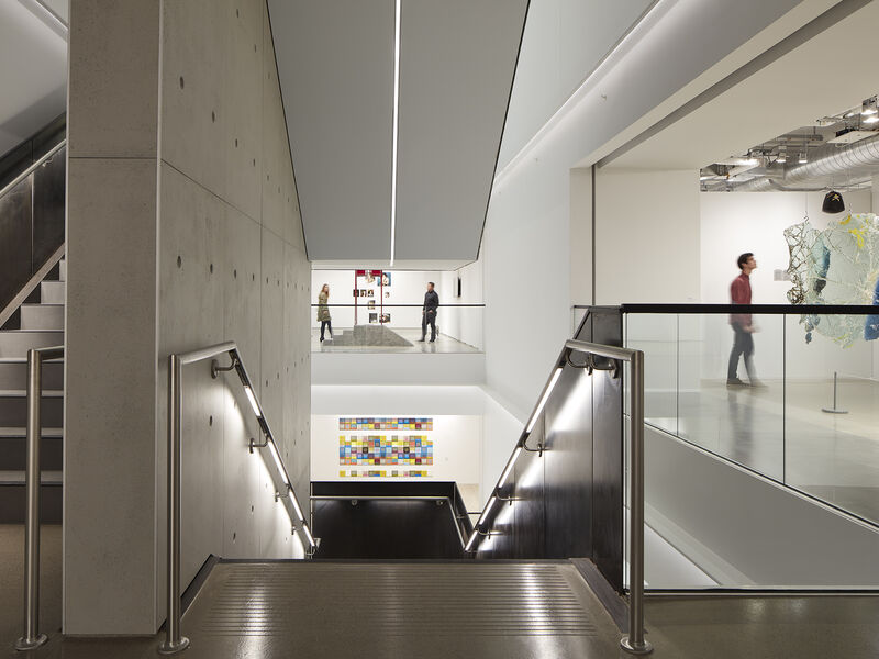 iew of SAIC Galleries open stairwell with patrons viewing artwork and walking around galleries