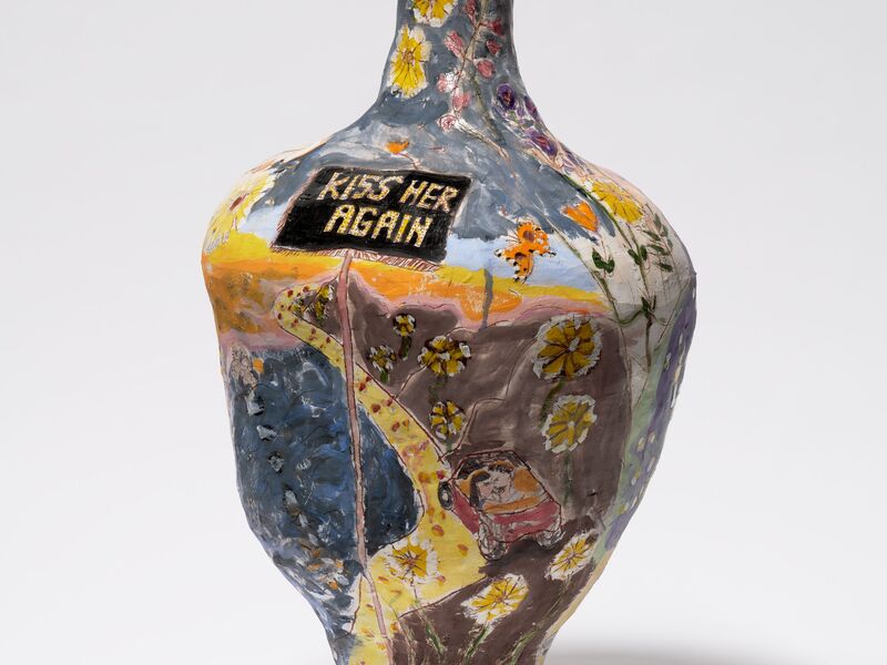Painted ceramic vase by Jennifer Rochlin that depicts flowers and a couple in a car. A sign reads "KISS HER AGAIN."