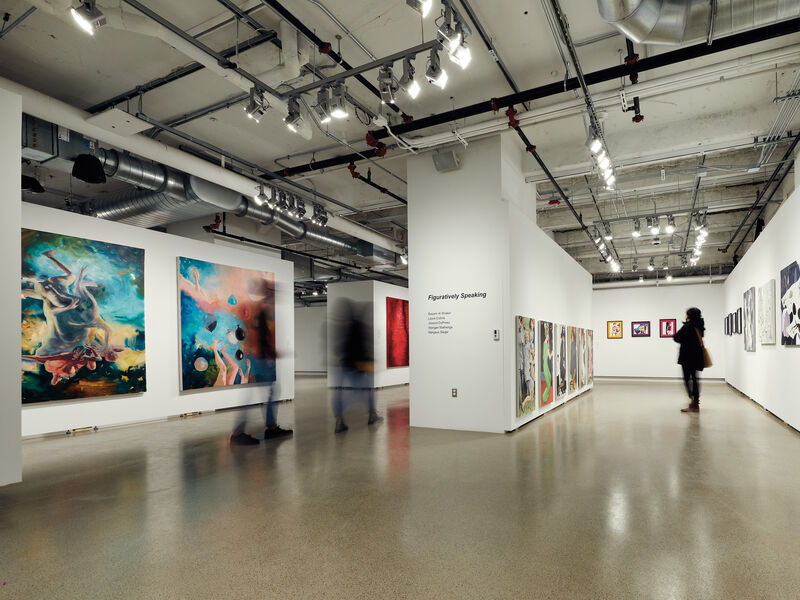 Two people walk through SAIC Galleries.