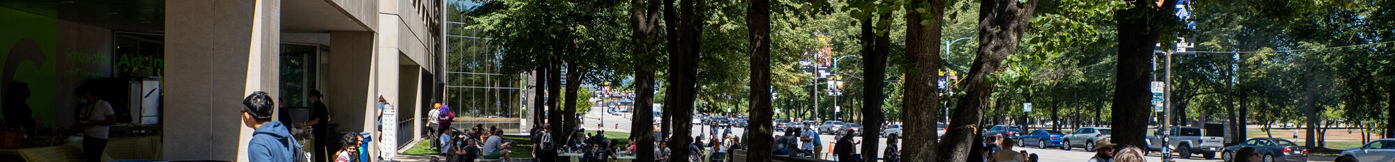 A large gathering of students sitting outside on the SAIC campus.