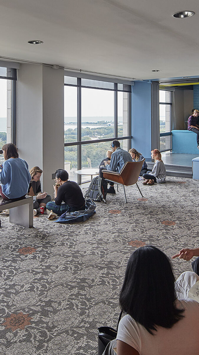 Interior shot of students gathered around the lounge outside CAPX offices.