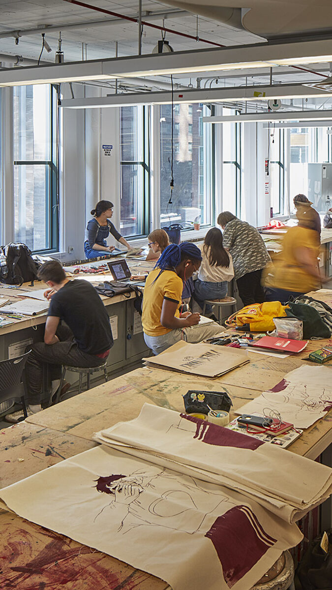 Interior shot of a print studio with students.