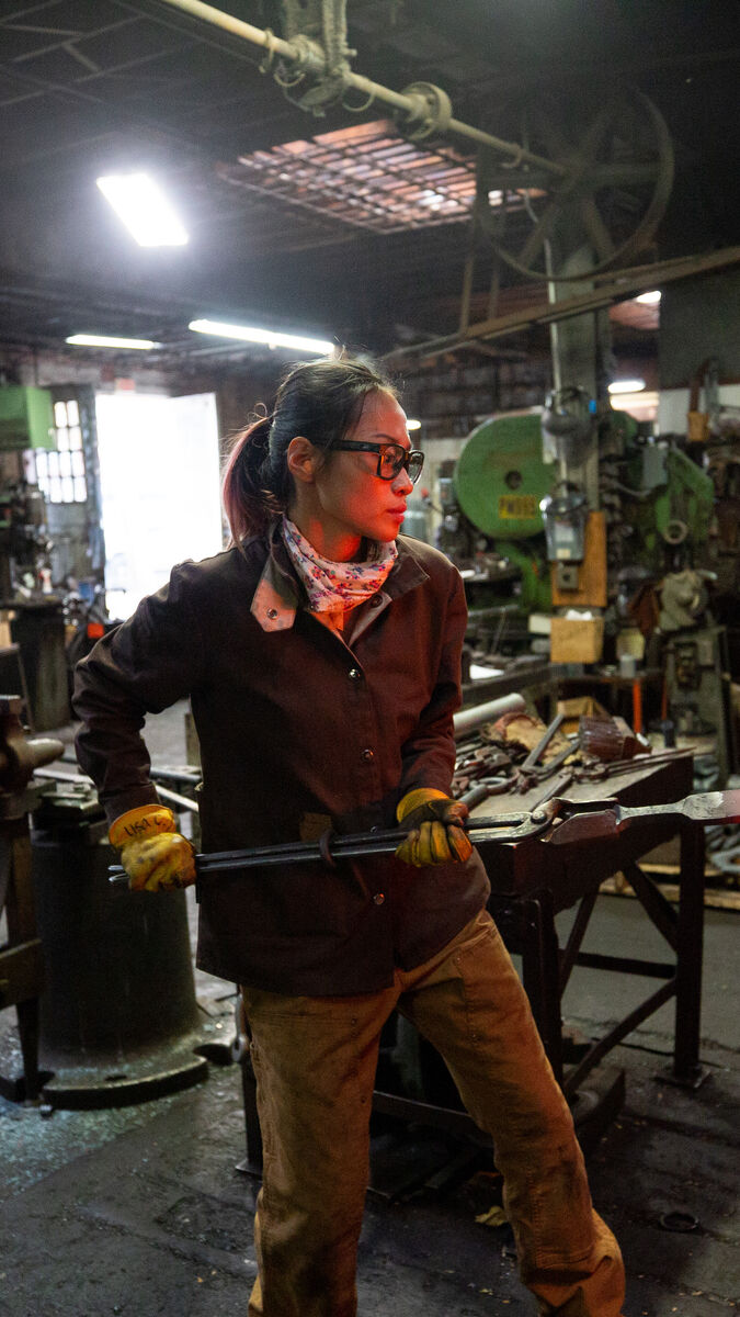 A person in a metal works studio. 