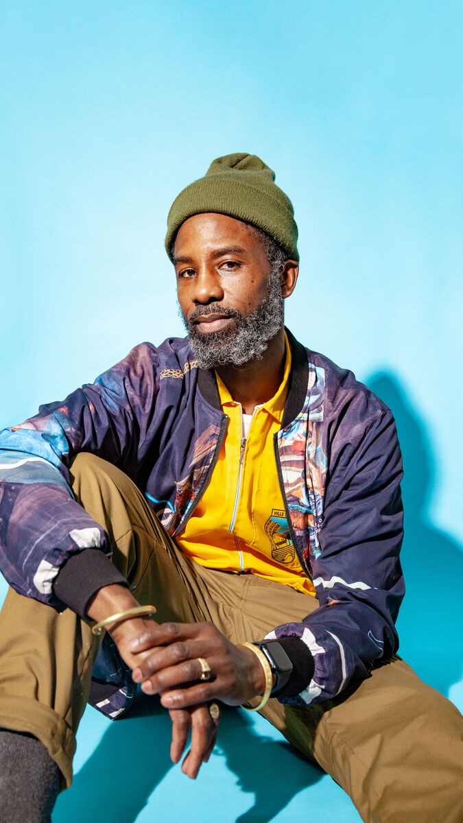 An image of Nyugen E. Smith against a bright blue background. 