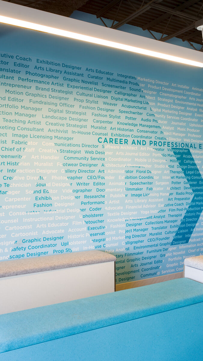 The CAPX offices, showing a large wall made up of text detailing different careers in art and design.