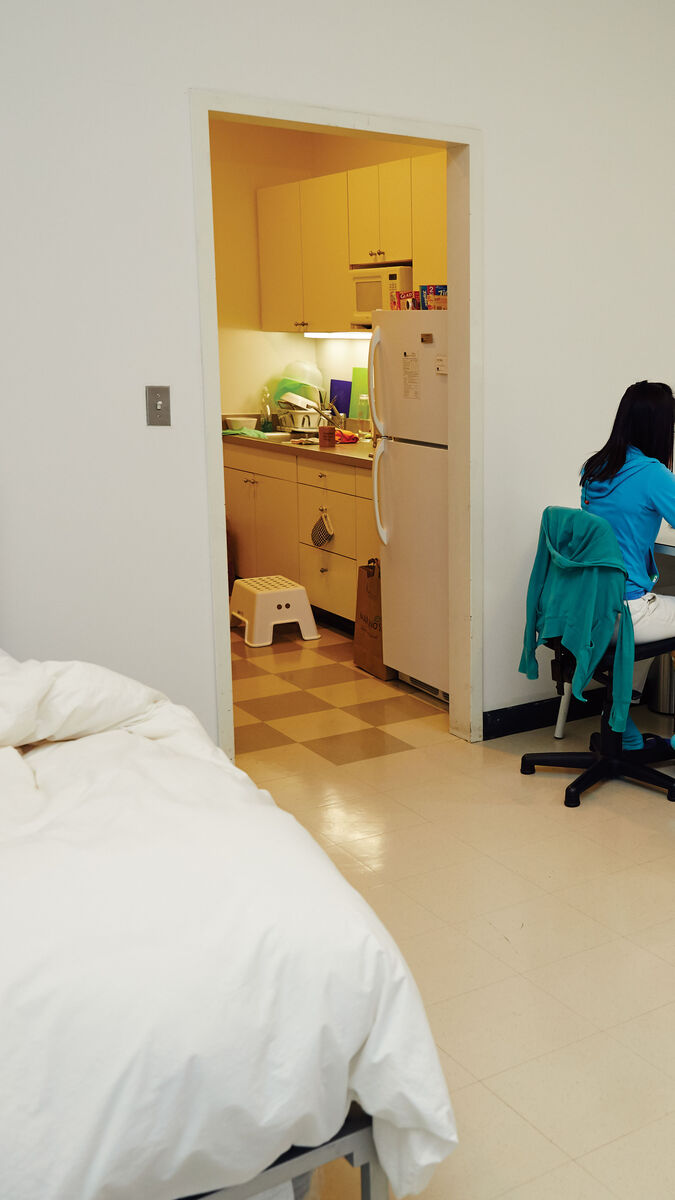A student works at their desk in the dorms