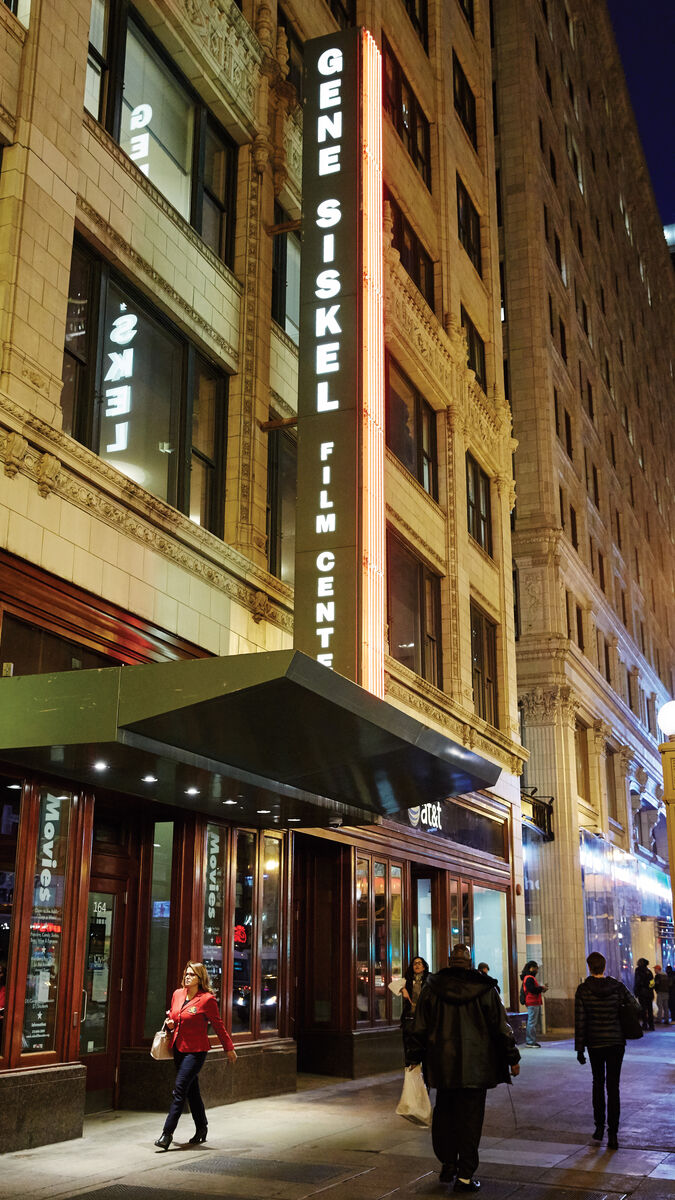 The facade of the Gene Siskel Film Center at night.