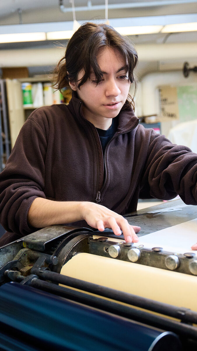 A student working in the Visual Communication Design letterpress studio.