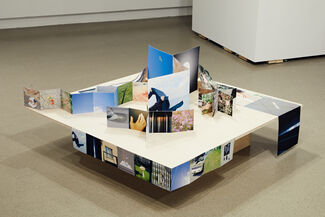 A group of small photographs arranged three dimensionally