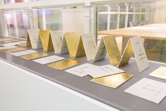Folded cards with gold plating on some of them.