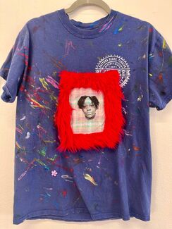 Purple tie-dye shirt with paint splatters and a fur-framed portrait in the middle