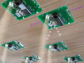 Numbered electronic chips adhered to a plank of wood by Anders Nereim 