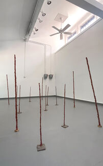 Sculptural pieces scattered around a gallery space by Olivia JS Lee