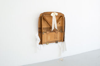 An installation by Kitty Rauth of a table folded against the wall like a murphy bed