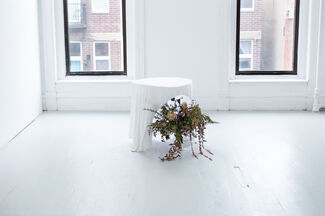 Art installation by Kitty Rauth of a floral arrangement under a table