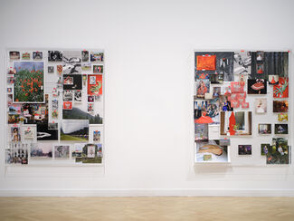 Various portraits and subjects displayed on a blank wall. 