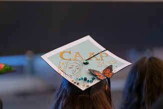 A close-up shot of the back of a student's graduation cap, that says CAAP 2025.