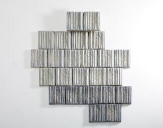 Grayscale square blocks forming six rows of varying widths. 