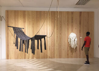 A person viewing Yasmin Spiro's sculptural work in a gallery space. 