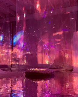 Pink, purple and blue light and color projection and installation that resembles a galaxy by Valerie Xanos. 