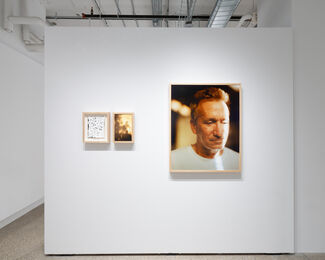 Three framed prints by James Baroz installed in a gallery space. 