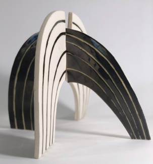 Sculpture of intersecting black and white semicircles by Lora Fosberg. 