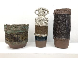 Three ceramic vessels against a white background.