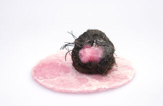 A pink and grey sculptural piece of artwork.