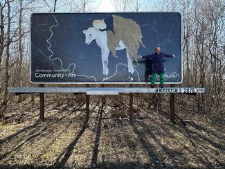 A billboard that shows an illustration of a cow against a blue background.