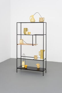 Ceramic objects on a steel shelf.