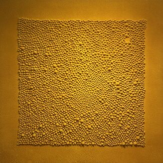 Detail of a multitude of raised golden dots form the shape of a square against a golden background, by Gunjan Chawla Kumar. 