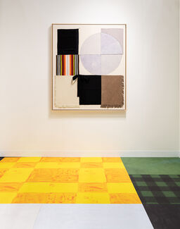 A geometric painting with bright colors on a wall with yellow and green checkerboard floors.