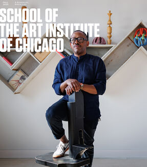 Portrait of Norman Teague, an adult Black person with a medium-dark skin tone, posing with a sculpture. "Fall 2025 School of the Art Institute of Chicago, a Biannual Magazine" is in bold text. 