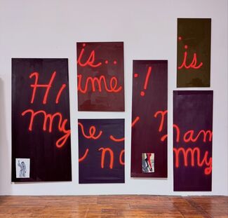Six panels with "Hi! My Name is..." painted on them in red by Peter Fagundo