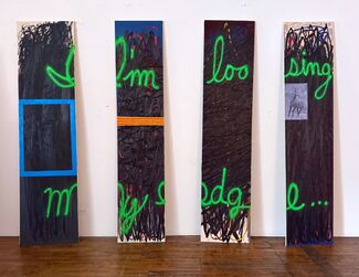 Four panels with "I'm Loosing My Edge" painted on them in green, by Peter Fagundo.