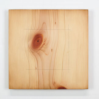 A square painted onto a block of wood. 