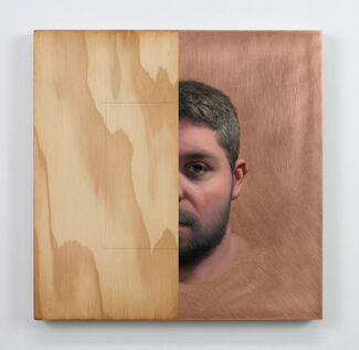 Wood block with half a square painted on the left side and half of a portrait of an adult's face. 