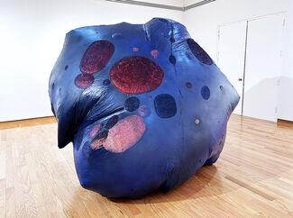 A large inflatable sculpture painted in blues and reds.