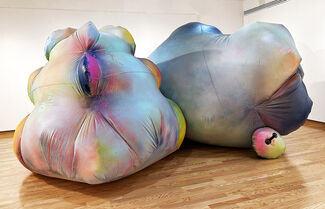 Two brightly painted inflatable sculptures in a gallery setting.