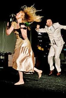 Two people with fair skin tones dancing. 