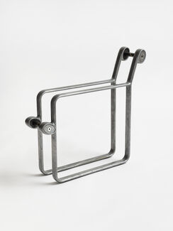A silver square-shaped object resembling the structure of a chair.  