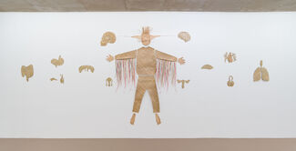 Sculptural mural of a figure and various human organs. 